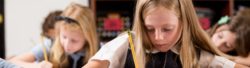An elementary school student writing her academic work