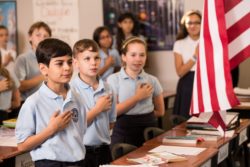 Children place their hands over their hearts, recite the pledge of allegiance, and experience physical sensations of patriotism internally