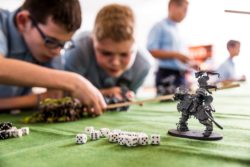 Children command their troops on a large war simulation