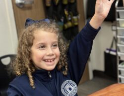 Girl raising her hand in class